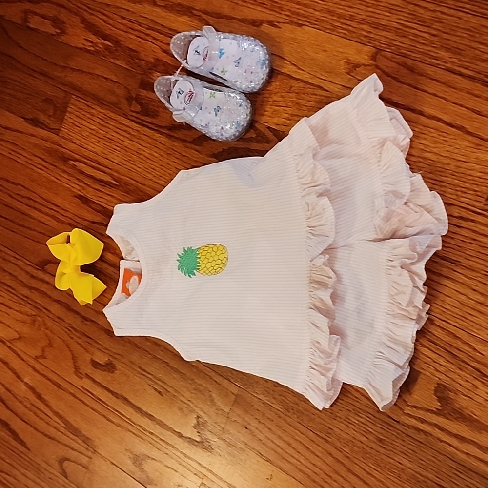 New 3 month seersucker pineapple outfit w jelly sandals and a yellow hair clip.
